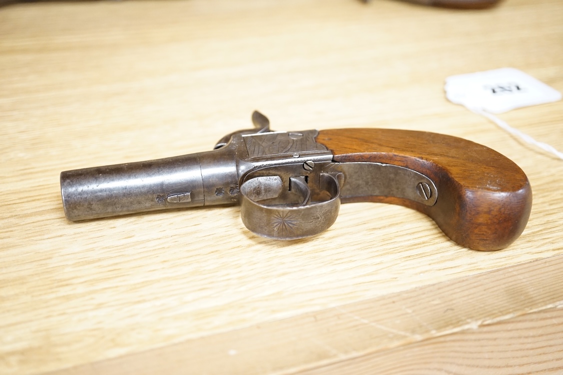 A boxlock percussion pocket pistol with turn off barrel, Birmingham proofs, trophy engraved frame, and slab walnut butt